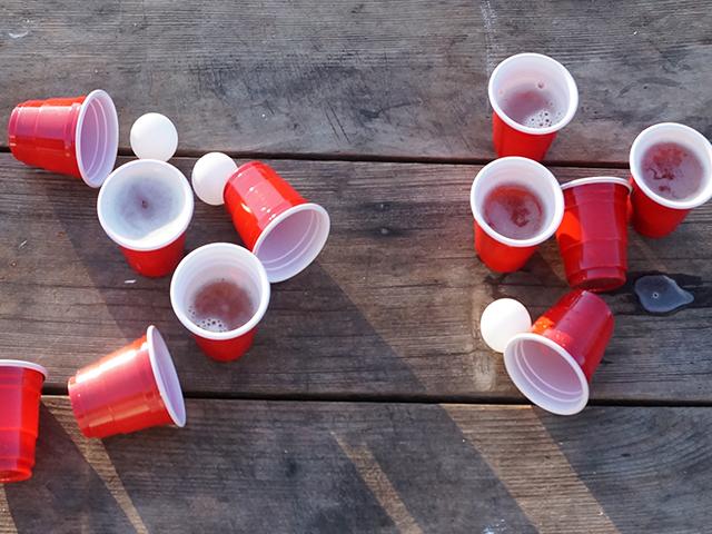 clear signs of beer pong -- red cups and ping pong balls